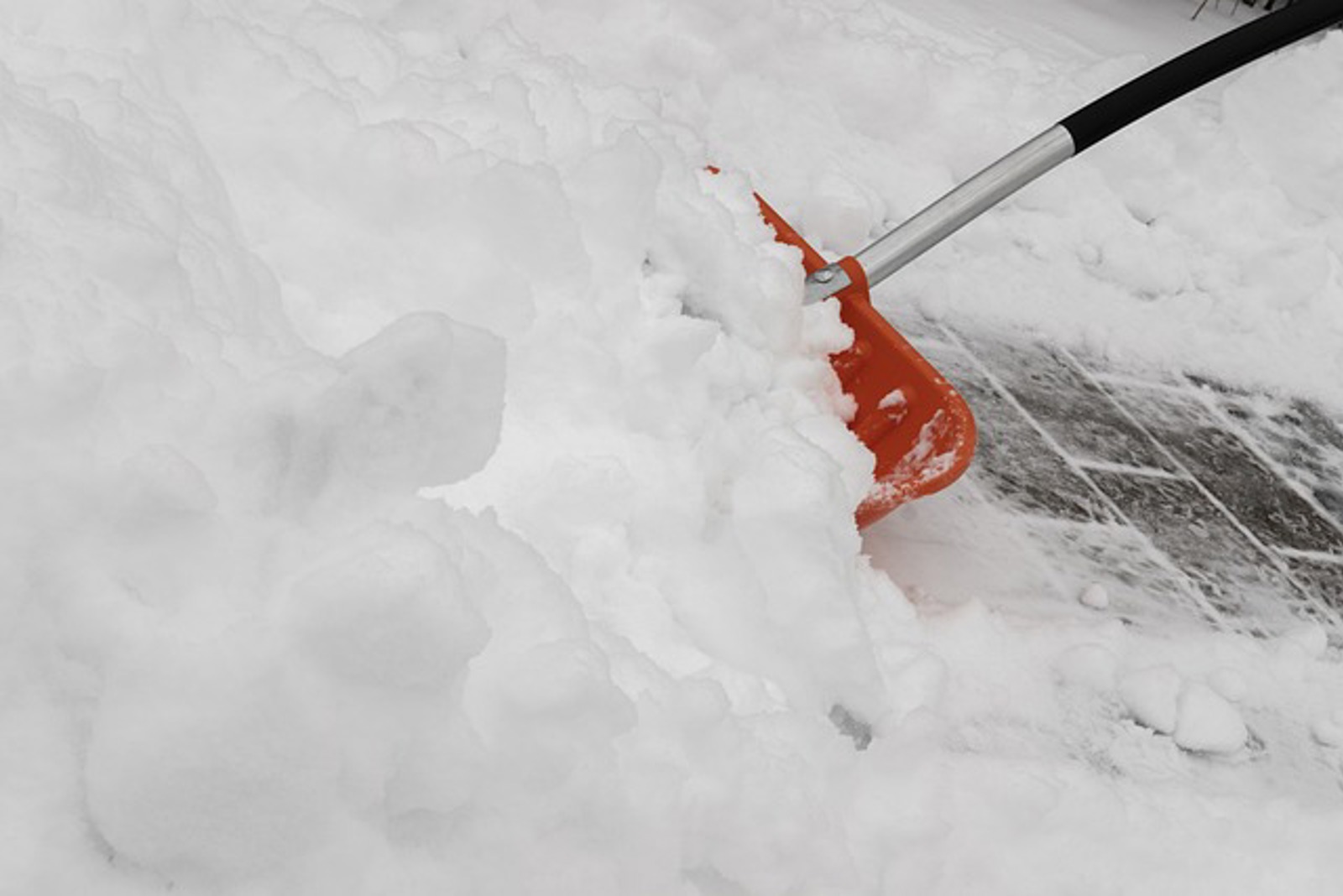 Shoveling snow on a sidewalk